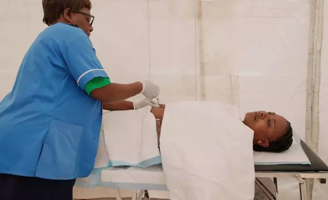 A nurse administers lenacapavir to Tambudzai Ndlovu during the launch of the new HIV prevention drug in Harare, Zimbabwe, Thursday, Feb. 19, 2026. (AP Photo/Aaron Ufumeli)