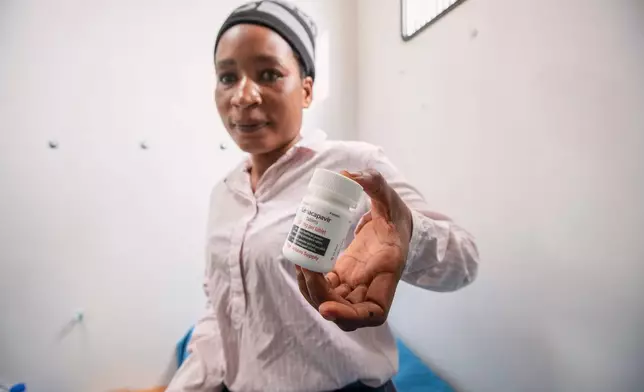 Constance Mukoloka holds a bottle of lenacapavir tablets after receiving a shot of the new HIV prevention drug in Harare, Zimbabwe, Thursday, Feb. 19, 2026. (AP Photo/Aaron Ufumeli)