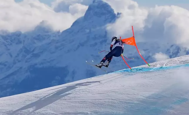 United States' Lindsey Vonn crashes into a gate during an alpine ski women's downhill race, at the 2026 Winter Olympics, in Cortina d'Ampezzo, Italy, Sunday, Feb. 8, 2026. (AP Photo/Jacquelyn Martin)