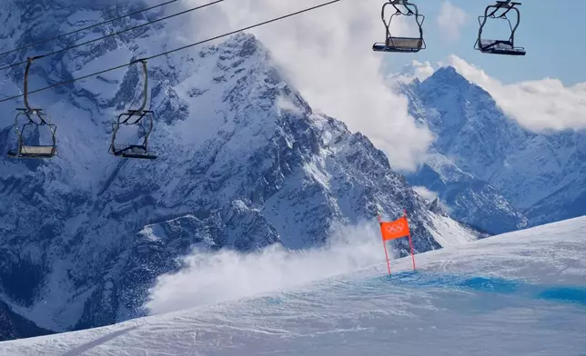 A cloud of snow is created by the crash of United States' Lindsey Vonn during an alpine ski women's downhill race, at the 2026 Winter Olympics, in Cortina d'Ampezzo, Italy, Sunday, Feb. 8, 2026. (AP Photo/Jacquelyn Martin)