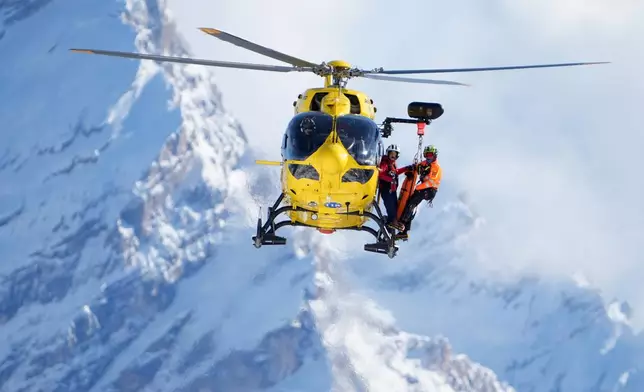 A rescue helicopter arrives after United States' Lindsey Vonn crashed during an alpine ski women's downhill race, at the 2026 Winter Olympics, in Cortina d'Ampezzo, Italy, Sunday, Feb. 8, 2026. (AP Photo/Jacquelyn Martin)