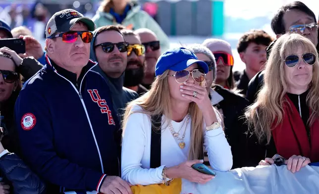 Spectators react after United States' Lindsey Vonn crashed during an alpine ski women's downhill race, at the 2026 Winter Olympics, in Cortina d'Ampezzo, Italy, Sunday, Feb. 8, 2026. (AP Photo/Robert F. Bukaty)