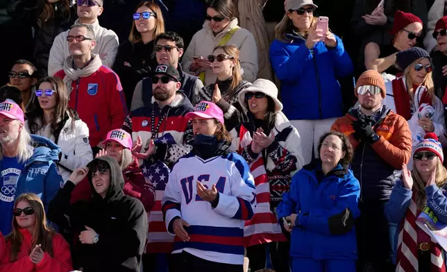 Fans of the United States react after United States' Lindsey Vonn's crash during an alpine ski women's downhill race, at the 2026 Winter Olympics, in Cortina d'Ampezzo, Italy, Sunday, Feb. 8, 2026. (AP Photo/Andy Wong)