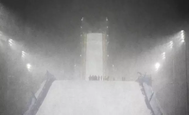 Heavy snow falls before the women's freestyle skiing big air finals at the 2026 Winter Olympics, in Livigno, Italy, Monday, Feb. 16, 2026. (AP Photo/Andy Bao)