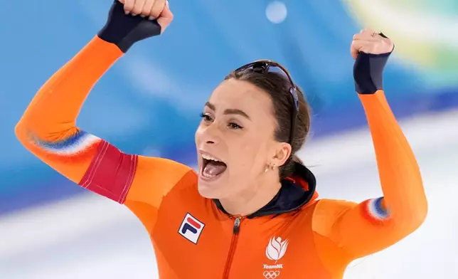Femke Kok of the Netherlands celebrates winning the gold medal in the women's 500 meters speedskating race at the 2026 Winter Olympics, in Milan, Italy, Sunday, Feb. 15, 2026. (AP Photo/Luca Bruno)