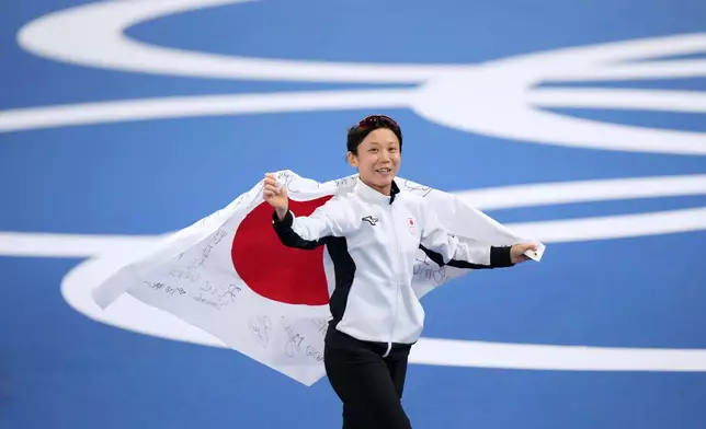 Miho Takagi of Japan celebrates winning the bronze medal in the women's 500 meters speedskating race at the 2026 Winter Olympics, in Milan, Italy, Sunday, Feb. 15, 2026. (AP Photo/Luca Bruno)