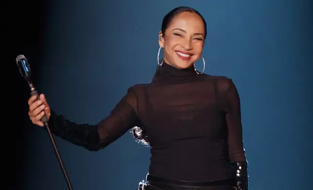 FILE - British singer Sade Adu performs during her "Soldiers of Love" concert in Sao Paulo, Brazil, on Oct. 20, 2011. (AP Photo/Andre Penner, File)