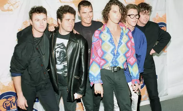 FILE - Members of the Australian rock group INXS, from left, Garry Gary Beers, Andrew Farriss, Jon Farriss, Michael Hutchence, Kirk Pengilly and Tim Farriss appear at the 7th annual American MTV Video Music Awards in Universal City, Calif., on Sept. 6, 1990. (AP Photo/Kevork Djansezian, File)