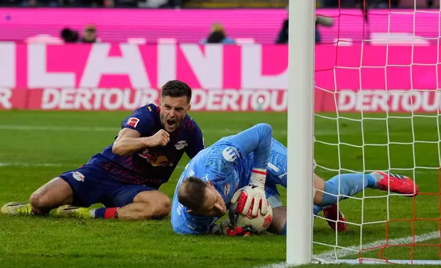 Leipzig's goalkeeper Peter Gulacsi saves during a German Bundesliga soccer match between Cologne and Leipzig in Cologne, Germany, Sunday, Feb. 8, 2026. (AP Photo/Martin Meissner)