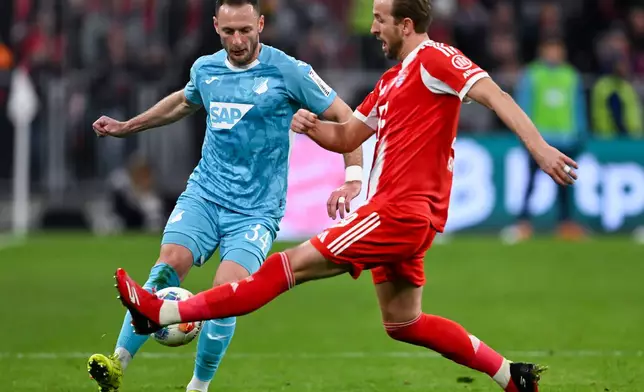 Bayern Munich's Harry Kane, right, and Hoffenheim's Vladimir Coufal in action during the Bundesliga soccer match between Bayern Munich and TSG 1899 Hoffenheim in Munich, Germany, Sunday Feb. 8, 2026. (Sven Hoppe/dpa via AP)