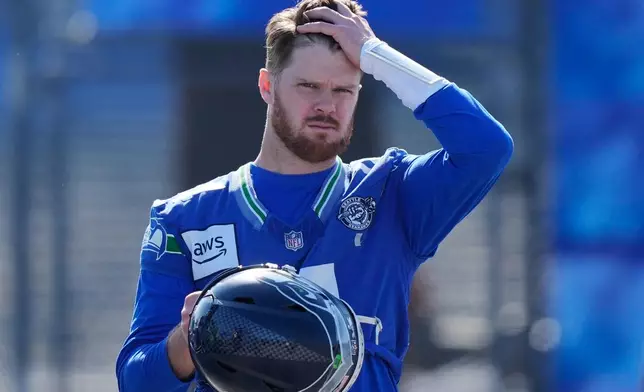 Seattle Seahawks quarterback Sam Darnold (14) arrives during an NFL Super Bowl football practice on Friday, Feb. 6, 2026, in San Jose, Calif., ahead of Super Bowl 60 between the New England Patriots and the Seattle Seahawks. (AP Photo/Brynn Anderson)
