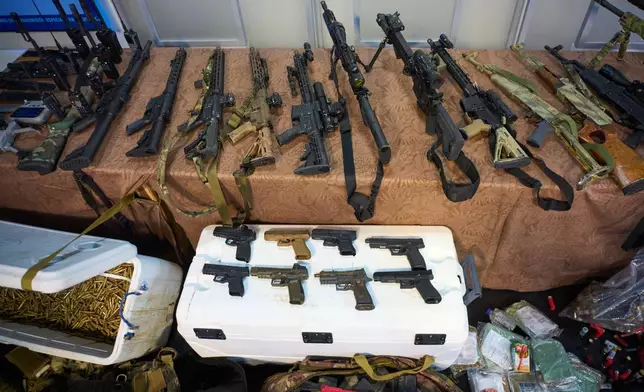 Weapons that Cuban authorities say were recovered from a speedboat in Cuban waters following a confrontation that left four people dead are displayed during a media presentation in Havana, Friday, Feb. 27, 2026. (AP Photo/Ramon Espinosa)