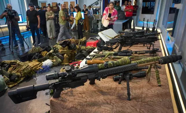 Weapons that Cuban authorities say were recovered from a speedboat in Cuban waters following a confrontation that left four people dead are displayed during a media presentation in Havana, Friday, Feb. 27, 2026. (AP Photo/Ramon Espinosa)