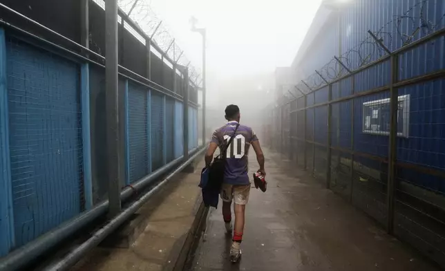 An inmate walks off the field after playing rugby at the Valparaiso Prison Complex in Valparaiso, Chile, as part of a social reintegration program, Thursday, Jan. 29, 2026. (AP Photo/Cristobal Escobar)