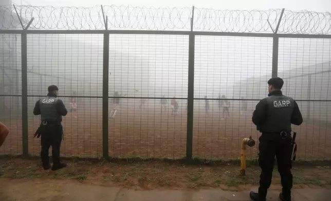 Prison guards watch inmates playing rugby at the Valparaiso Prison Complex in Valparaiso, Chile, as part of a social reintegration program, Thursday, Jan. 29, 2026. (AP Photo/Cristobal Escobar)