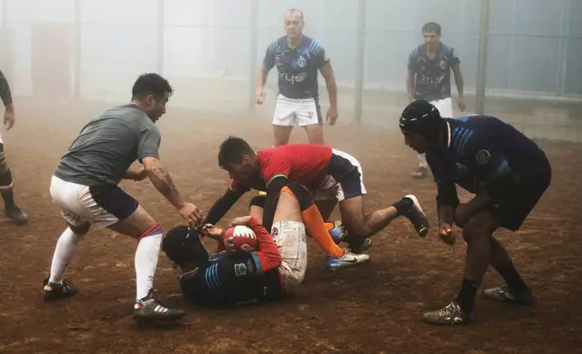 Inmates play rugby at the Valparaiso Prison Complex in Valparaiso, Chile, as part of a social reintegration program, Thursday, Jan. 29, 2026. (AP Photo/Cristobal Escobar)