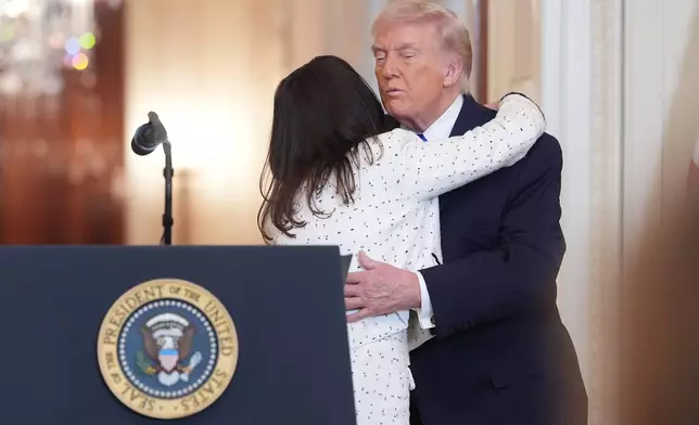 Allyson Phillips, the mother of Laken Riley, is hugged by President Donald Trump, during an event to proclaim "Angel Family Day" in the East Room of the White House, Monday, Feb. 23, 2026, in Washington. (AP Photo/Evan Vucci)