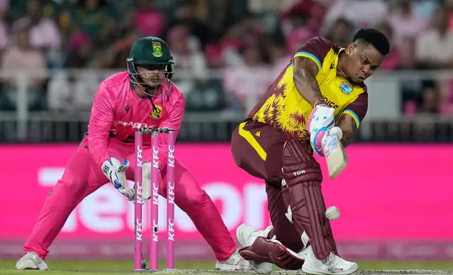 West Indies batsman Shimron Hetmyer, right, misplay a delivery as South Africa's wicketkeeper Quinton de Kock watches on during the T20 International cricket match between South Africa and West Indies, in Johannesburg, South Africa, Saturday, Jan. 31, 2026. (AP Photo/Themba Hadebe)