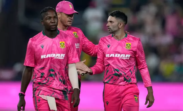 South Africa's bowler Keshav Maharaj, right, celebrates with his teammates after taking a wicket during the T20 International cricket match between South Africa and West Indies, in Johannesburg, South Africa, Saturday, Jan. 31, 2026. (AP Photo/Themba Hadebe)