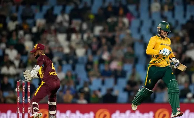 South Africa's batsman Ryan Rickelton, right, runs and survive a run out attempt by West Indies wicketkeeper Shai Hope during the T20 International cricket match between South Africa and West Indies, in Centurion, South Africa, Thursday, Jan. 29, 2026. (AP Photo/Themba Hadebe)
