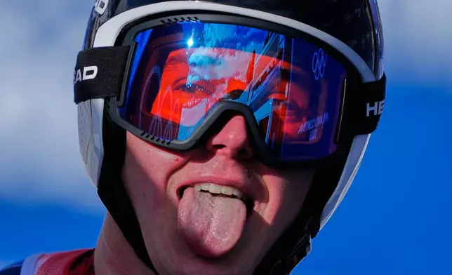 Switzerland's Franjo von Allmen sticks his tongue out at the finish area, during a men's super-G race, at the 2026 Winter Olympics, in Bormio, Italy, Wednesday, Feb.11, 2026. (AP Photo/Julia Demaree Nikhinson)