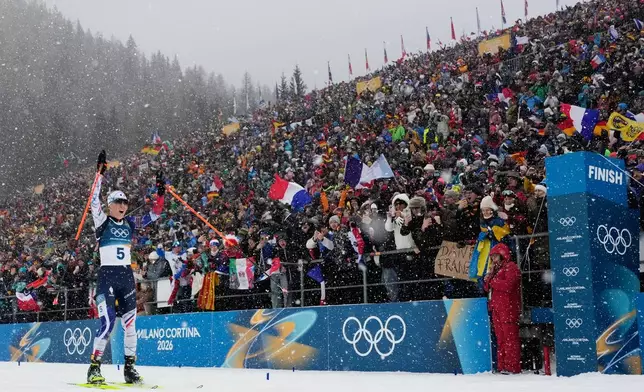 Oceane Michelon, of France, skis to the finish line for gold in the women's 12.5-kilometer mass start biathlon race at the 2026 Winter Olympics in Anterselva, Italy, Saturday, Feb. 21, 2026. (AP Photo/David J. Phillip)