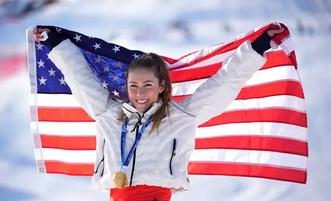 United States' Mikaela Shiffrin celebrates winning the gold medal in an alpine ski, women's slalom race, at the 2026 Winter Olympics, in Cortina d'Ampezzo, Italy, Wednesday, Feb. 18, 2026. (AP Photo/Jacquelyn Martin)
