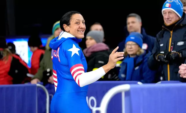 United States' Elana Meyers Taylor, front, smiles at the finish during a two women bobsled run at the 2026 Winter Olympics, in Cortina d'Ampezzo, Italy, Friday, Feb. 20, 2026. (AP Photo/Alessandra Tarantino)