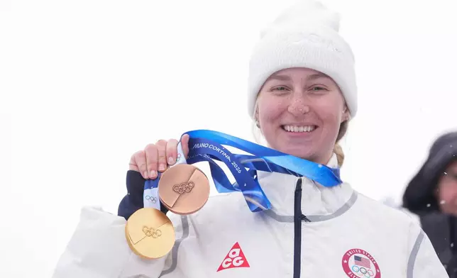 Bronze medalist United States' Elizabeth Lemley wears her gold medal alongside her bronze medal after the women's freestyle skiing dual moguls finals at the 2026 Winter Olympics, in Livigno, Italy, Saturday, Feb. 14, 2026. Lemley won the gold medal in women's moguls earlier this week. (AP Photo/Lindsey Wasson)