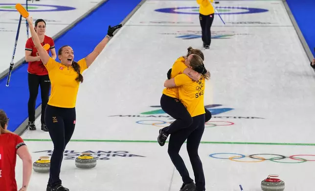Team Sweden celebrates defeating Switzerland to win a women's curling gold medal match, at the 2026 Winter Olympics, in Cortina d'Ampezzo, Italy, Sunday, Feb. 22, 2026.(AP Photo/Fatima Shbair)