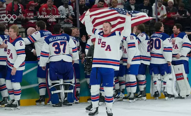 United States celebrate after defeating Canada in a men's ice hockey gold medal game between Canada and the United States at the 2026 Winter Olympics, in Milan, Italy, Sunday, Feb. 22, 2026. (AP Photo/Petr David Josek)