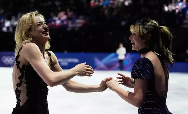 From left, Amber Glenn and Alysa Liu of the United States react after performing in the figure skating exhibition at the 2026 Winter Olympics, in Milan, Italy, Saturday, Feb. 21, 2026. (AP Photo/Ashley Landis)