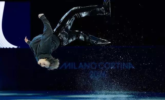 Ilia Malinin of the United States does a back flip during his performance in the figure skating exhibition at the 2026 Winter Olympics, in Milan, Italy, Saturday, Feb. 21, 2026. (AP Photo/Ashley Landis)