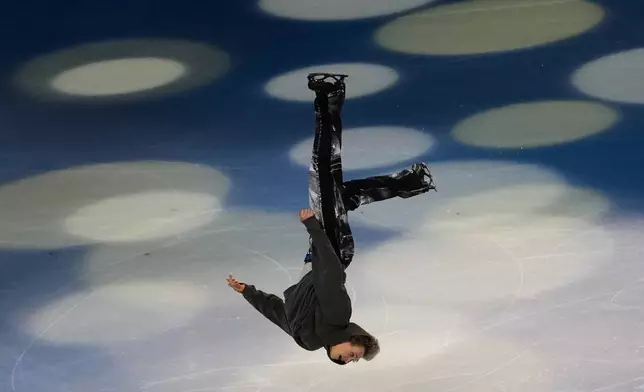 Ilia Malinin of the United States does a back flip during his performance in the figure skating exhibition at the 2026 Winter Olympics, in Milan, Italy, Saturday, Feb. 21, 2026. (AP Photo/Francisco Seco)