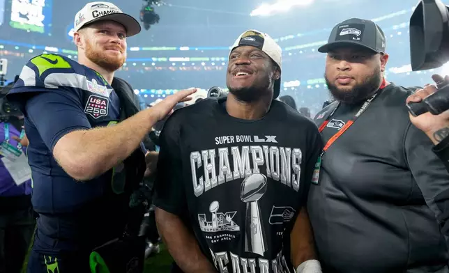 Seattle Seahawks quarterback Sam Darnold, left, and teammate running back Kenneth Walker III celebrate after defeating the New England Patriots in the NFL Super Bowl 60 football game, Sunday, Feb. 8, 2026, in Santa Clara, Calif. (AP Photo/Brynn Anderson)