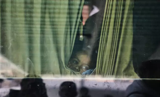 Juman Al-Najjar, a 3-year-old Palestinian patient, looks out from a vehicle with other patients in Khan Younis as they head to the Rafah crossing, leaving the Gaza Strip for medical treatment abroad, Monday, Feb. 2, 2026. (AP Photo/Abdel Kareem Hana)