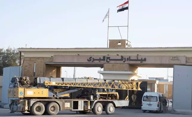 A crane enters the Egyptian gate of the Rafah crossing to the Gaza Strip, in Rafah, Egypt, Sunday, Feb. 1, 2026. (AP Photo/Mohamed Arafat)