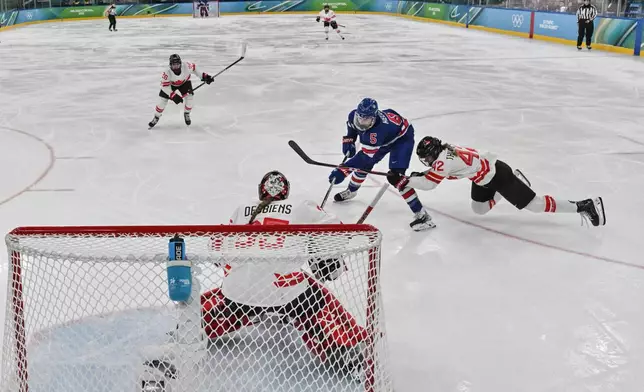 United States' Megan Keller (5) scores the winning goal during the women's ice hockey gold medal game between the United States and Canada at the 2026 Winter Olympics, in Milan, Italy, Thursday, Feb. 19, 2026. (Alexander Nemenov/Pool Photo via AP)