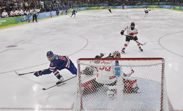 United States' Megan Keller (5) scores the winning goal during the women's ice hockey gold medal game between the United States and Canada at the 2026 Winter Olympics, in Milan, Italy, Thursday, Feb. 19, 2026. (Alexander Nemenov/Pool Photo via AP)