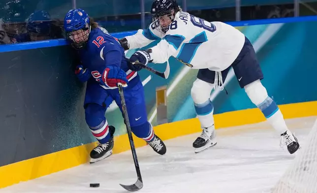 Finland's Ronja Savolainen, right, challenges United States' Kelly Pannek during a preliminary round match of women's ice hockey between the United States and Finland at the 2026 Winter Olympics, in Milan, Italy, Saturday, Feb. 7, 2026. (AP Photo/Petr David Josek)