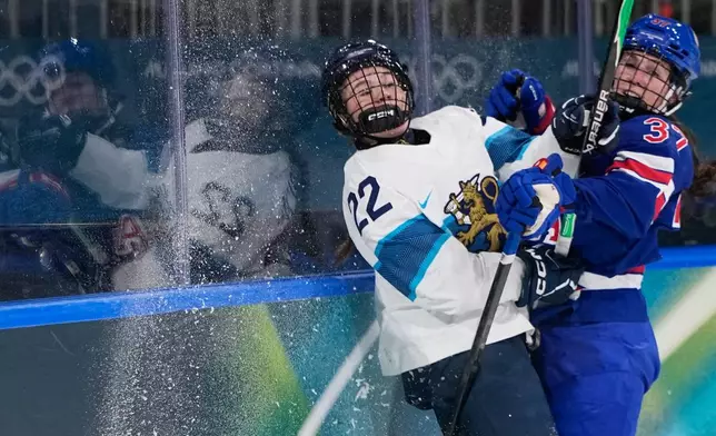 United States' Abbey Murphy, right, checks Finland's Julia Schalin during a preliminary round match of women's ice hockey between the United States and Finland at the 2026 Winter Olympics, in Milan, Italy, Saturday, Feb. 7, 2026. (AP Photo/Petr David Josek)