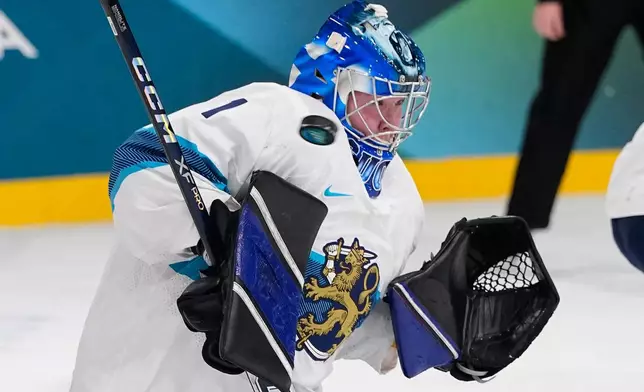 Finland's Sanni Ahola fails to make a save during a preliminary round match of women's ice hockey between the United States and Finland at the 2026 Winter Olympics, in Milan, Italy, Saturday, Feb. 7, 2026. (AP Photo/Petr David Josek)