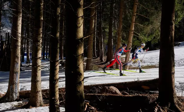 Ebba Andersson, of Sweden, right, and Heidi Weng, of Norway, compete in the cross country skiing women's 50km mass start classic at the 2026 Winter Olympics, in Tesero, Italy, Sunday, Feb. 22, 2026. (AP Photo/Evgeniy Maloletka)