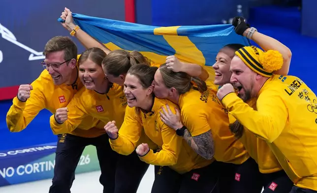 Sweden's Anna Hasselborg, Sara McManus, Sofia Scharback and Agnes Knochenhauer celebrate defeating Switzerland to win a women's curling gold medal match, at the 2026 Winter Olympics, in Cortina d'Ampezzo, Italy, Sunday, Feb. 22, 2026. (AP Photo/Misper Apawu)