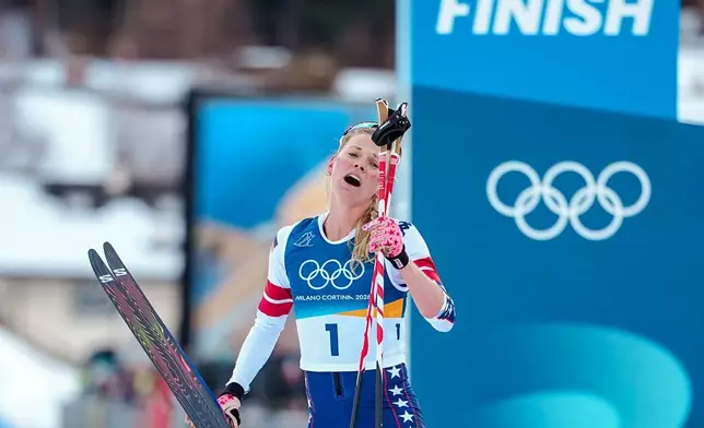 Jessie Diggins of the United States catches her breath after crossing the finish line in the cross country skiing women's 10km + 10km skiathlon at the 2026 Winter Olympics, in Tesero, Italy, Saturday, Feb. 7, 2026. (AP Photo/Matthias Schrader)