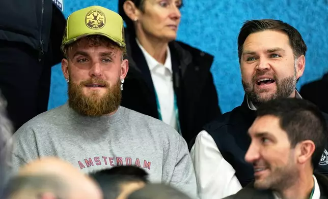 Jake Paul, left, and Vice President JD Vance attend a preliminary round match of women's ice hockey between the United States and Finland at the 2026 Winter Olympics, in Milan, Italy, Saturday, Feb. 7, 2026. (AP Photo/Petr David Josek)