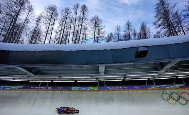 Puerto Rico's Kellie Delka slides down the track during a women's skeleton training session at the 2026 Winter Olympics, in Cortina d'Ampezzo, Italy, Monday, Feb. 9, 2026. (AP Photo/Aijaz Rahi)