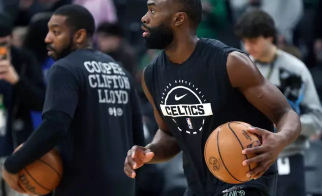 Boston Celtics' Jaylen Brown, right, warms up before an NBA basketball game against the Milwaukee Bucks, Sunday, Feb 1, 2026, in Boston. (AP Photo/Jim Davis)