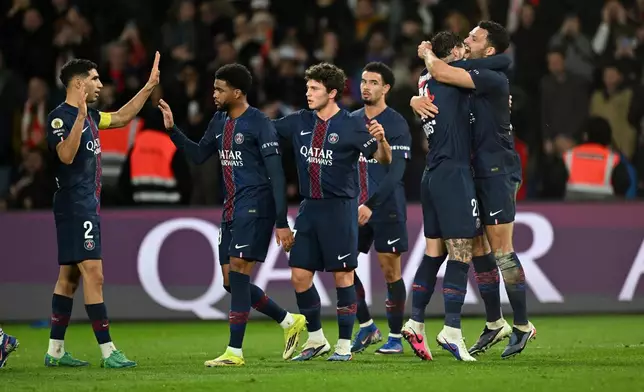 PSG's Goncalo Ramos, right, celebrates with teammates after scoring his side's third goal during the French League One soccer match between Paris Saint-Germain and Metz in Paris, France, Saturday, Feb. 21, 2026. (AP Photo/Emma Da Silva)