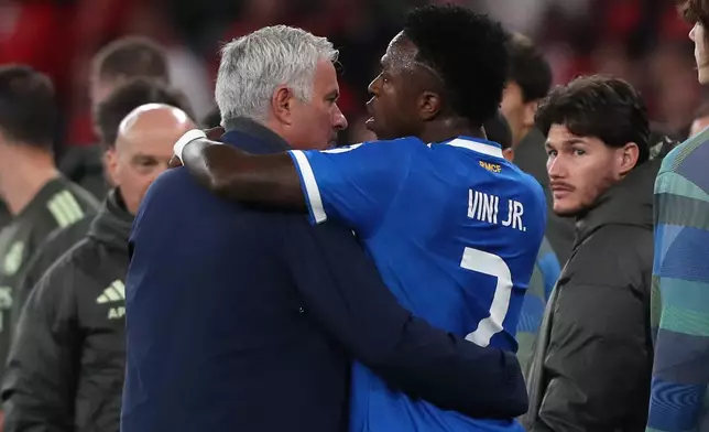 Real Madrid's Vinicius Junior argues with Benfica's head coach José Mourinho after scoring the opening goal during a Champions League playoff soccer match between SL Benfica and Real Madrid in Lisbon, Portugal, Tuesday, Feb. 17, 2026. (AP Photo/Pedro Rocha)